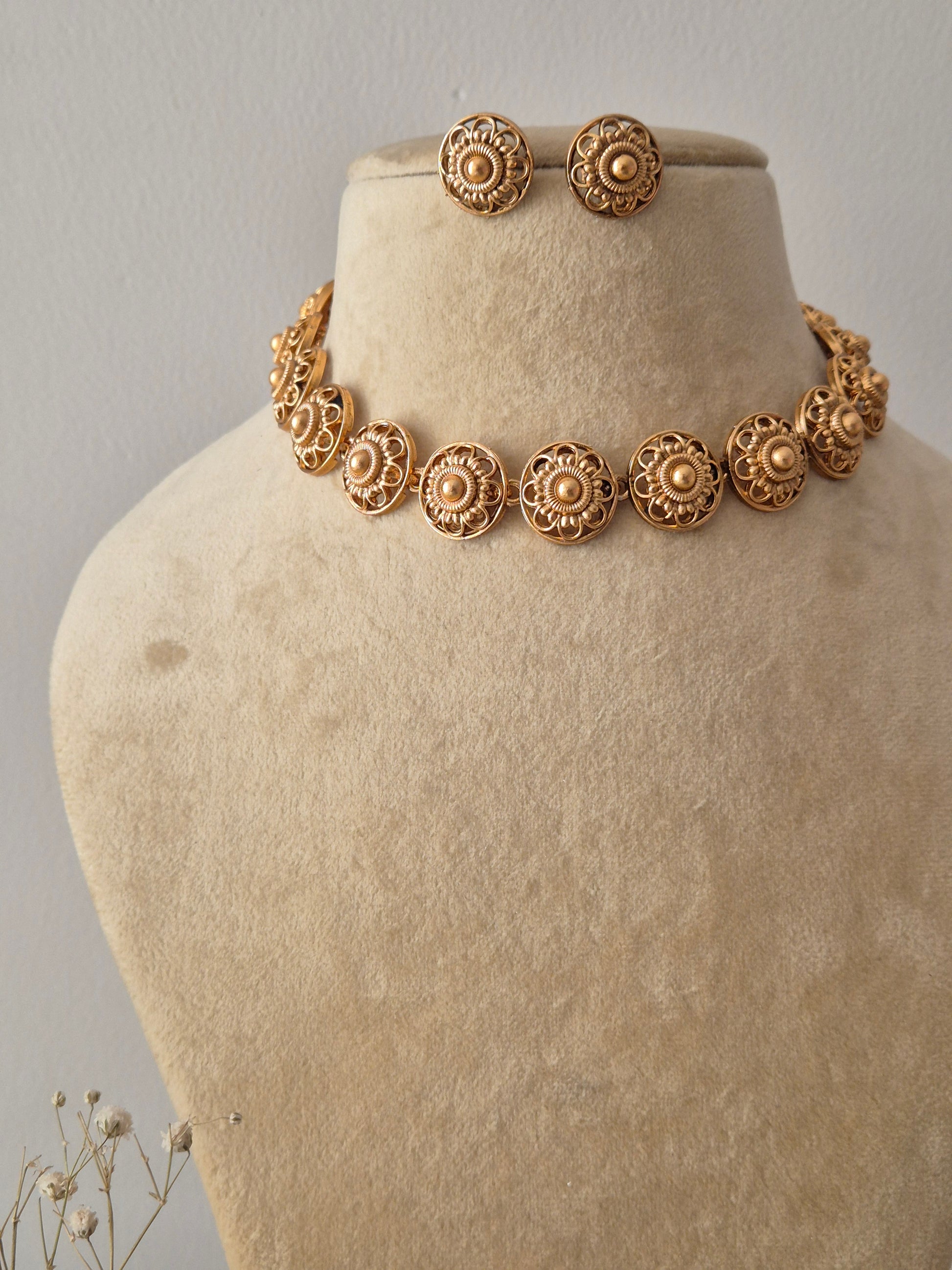 Antique-style  gold necklace set with multiple textured floral discs and coordinating round studs, perfect for modern Indian ethnic wear by naitri.in