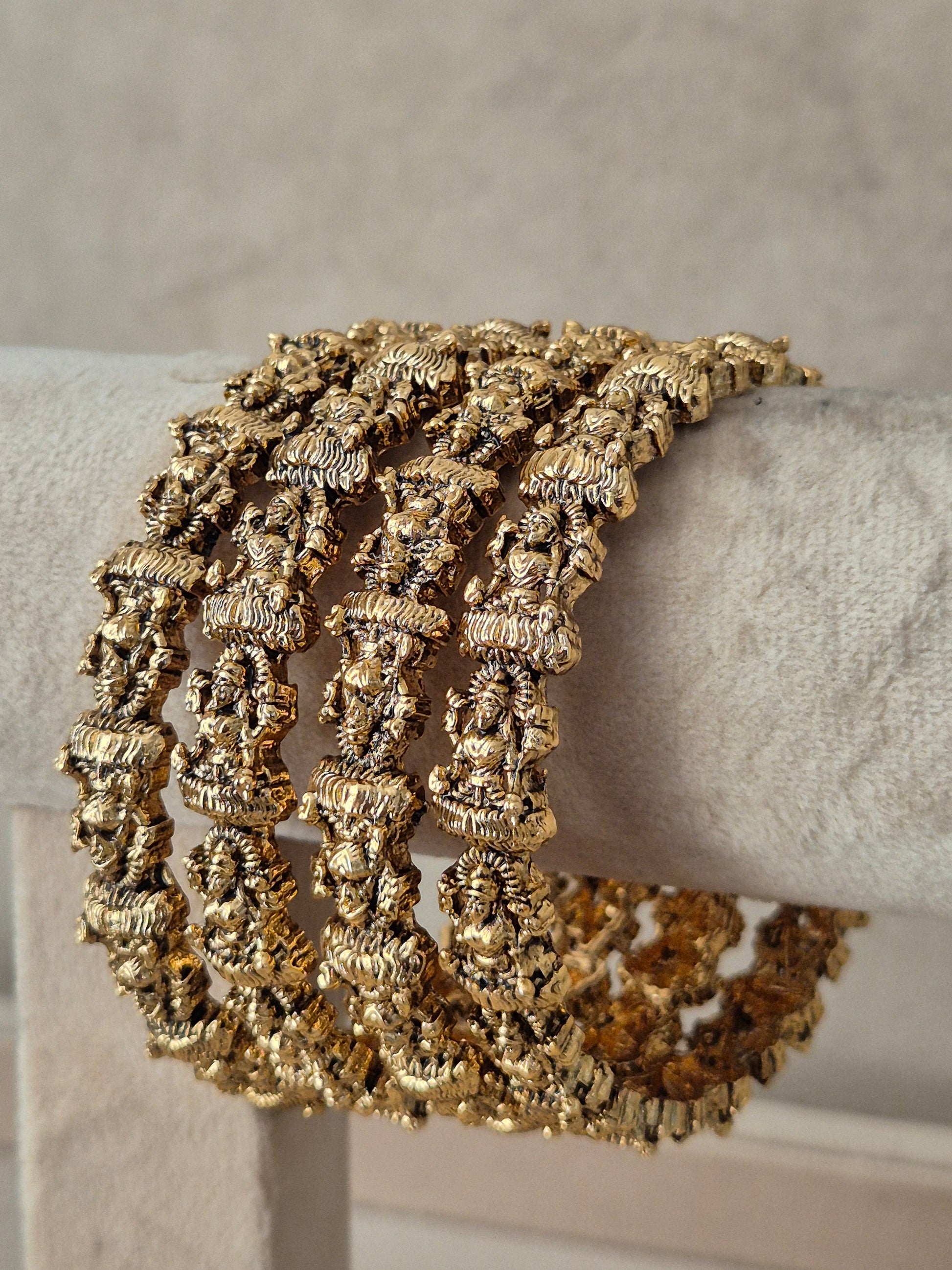 set of four gold-plated traditional Indian bangles featuring intricate temple architecture motifs, by naitri.in