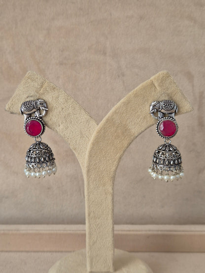 Naitri premium Devashri silver-toned traditional Indian dangle earrings with red accents, Intricate silver elephant and jhumka earrings with red gemstones and pearl drops by naitri.in