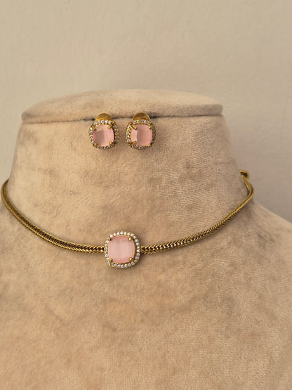Delicate gold choker necklace with a blush pink stone pendant and matching stud earrings by naitri.in