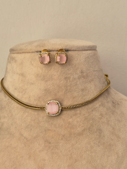 Delicate gold choker necklace with a blush pink stone pendant and matching stud earrings by naitri.in