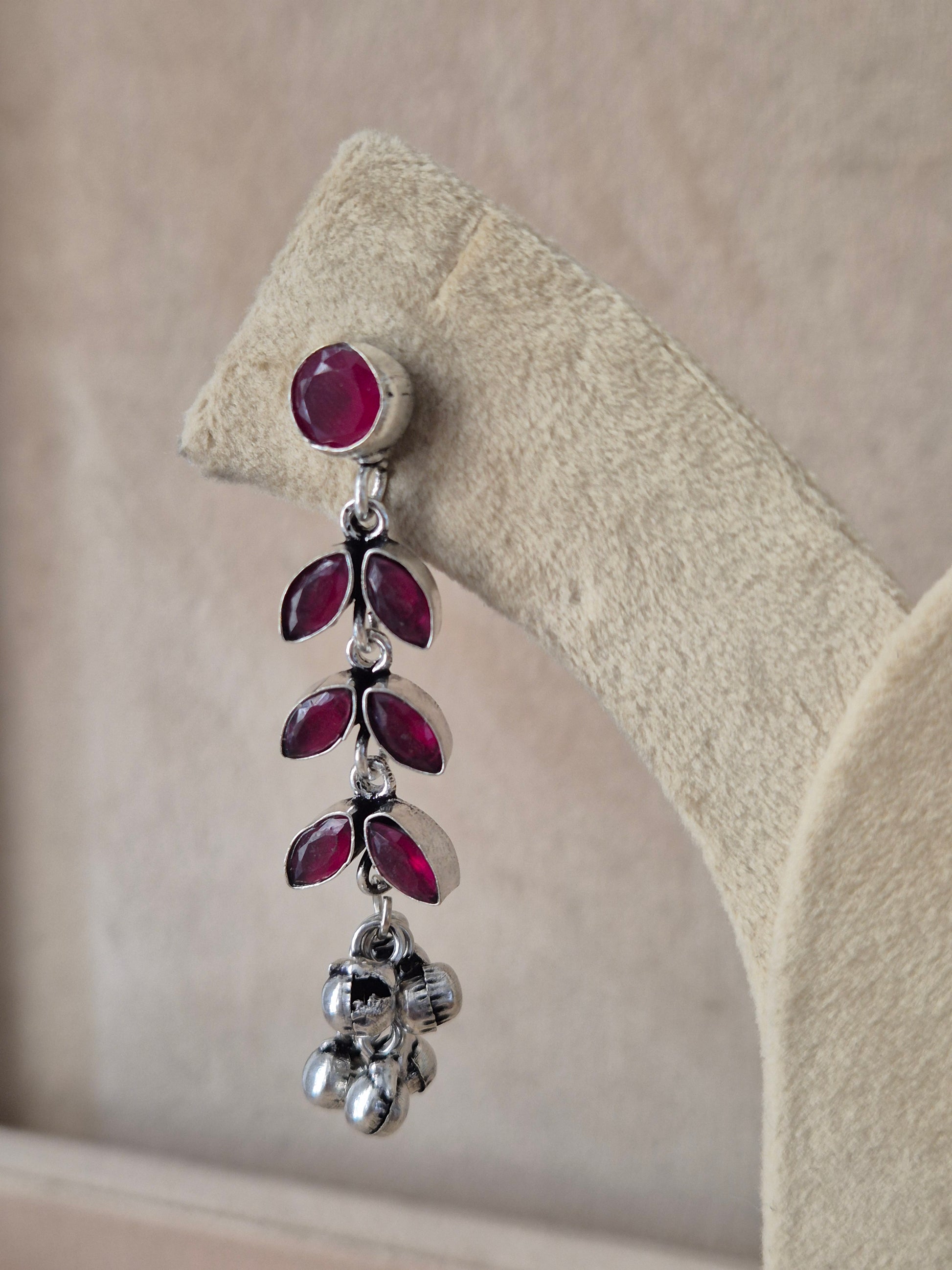 Dhritismita premium oxidized silver earrings with red leaf-patterned gemstones by Naitri.in