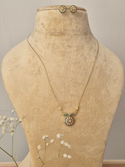 Gold-toned imitation jewelry set with invisible chain, pendant, and stud earrings by naitri.in