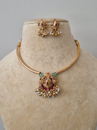 Traditional gold temple necklace set with pink and green stones and pearl droplets, including matching jhumka earrings by naitri.in