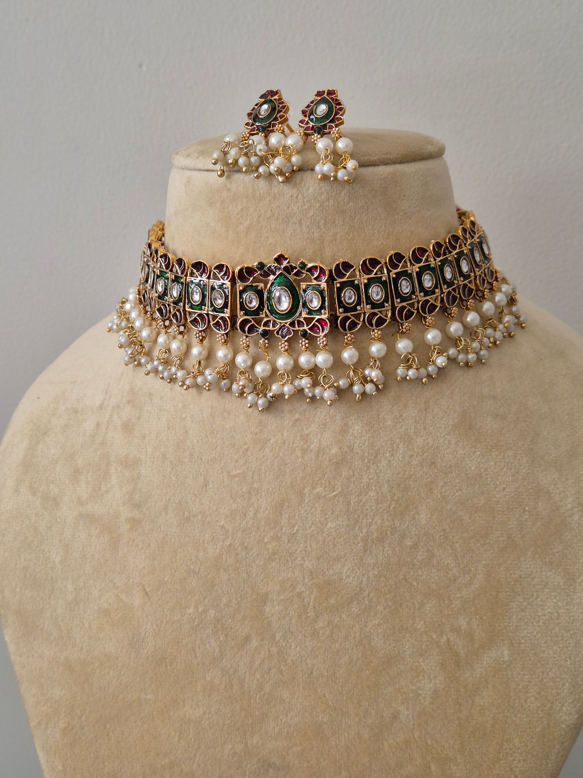 Traditional Antique Gold-Plated Necklace with Emerald Green and Ruby Pink Stones and Pearl Beads Antique gold choker set with pink and green stones and white pearl droplets, including matching circular stud earring by naitri.in