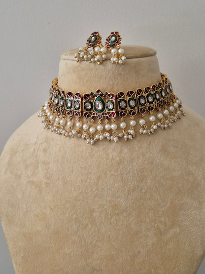 Traditional Antique Gold-Plated Necklace with Emerald Green and Ruby Pink Stones and Pearl Beads Antique gold choker set with pink and green stones and white pearl droplets, including matching circular stud earring by naitri.in