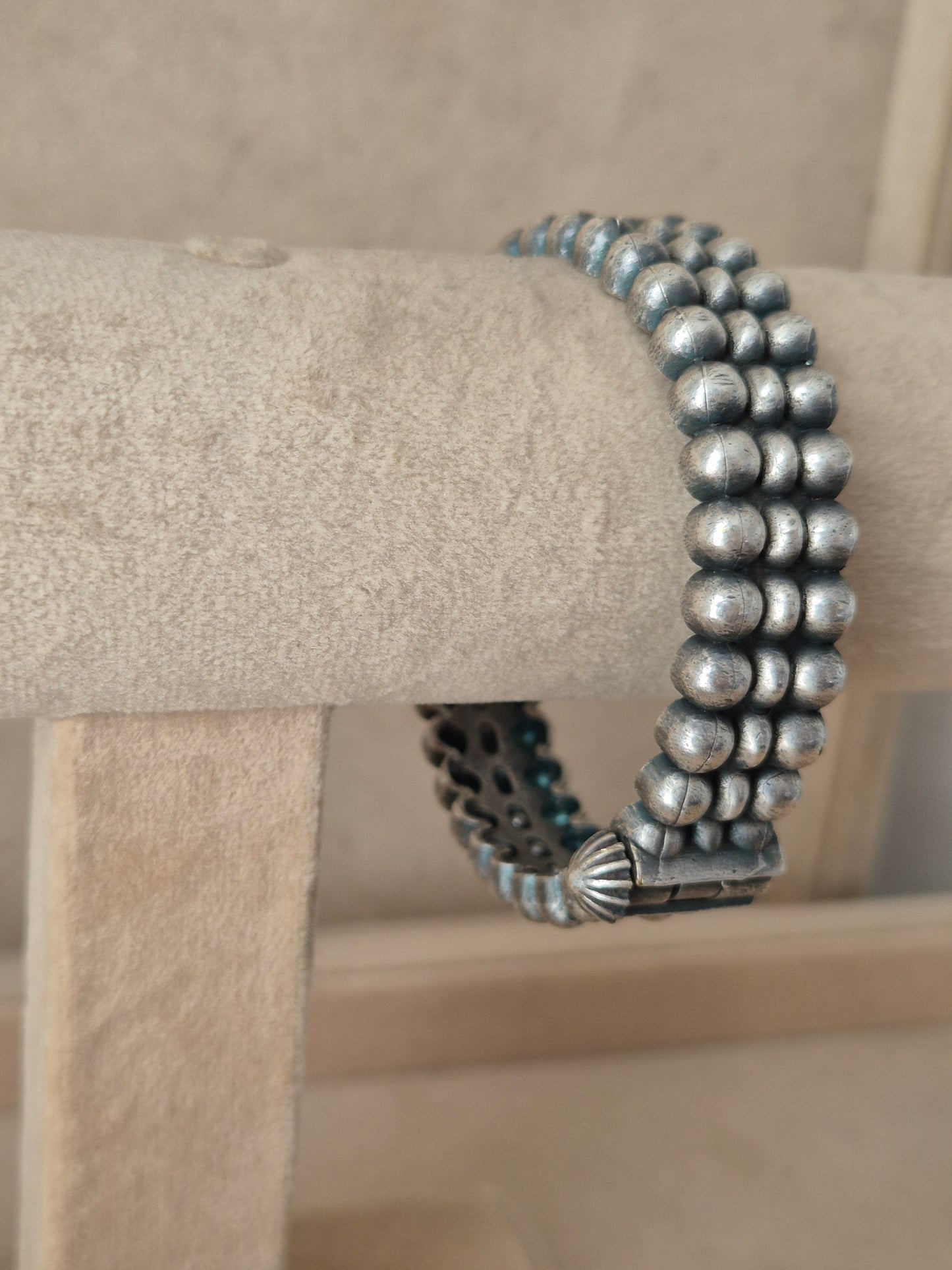 Close-up of Naitri premium silver oxidized bangle bracelet featuring traditional Indian style metalwork and a secure hinge clasp by naitri.in