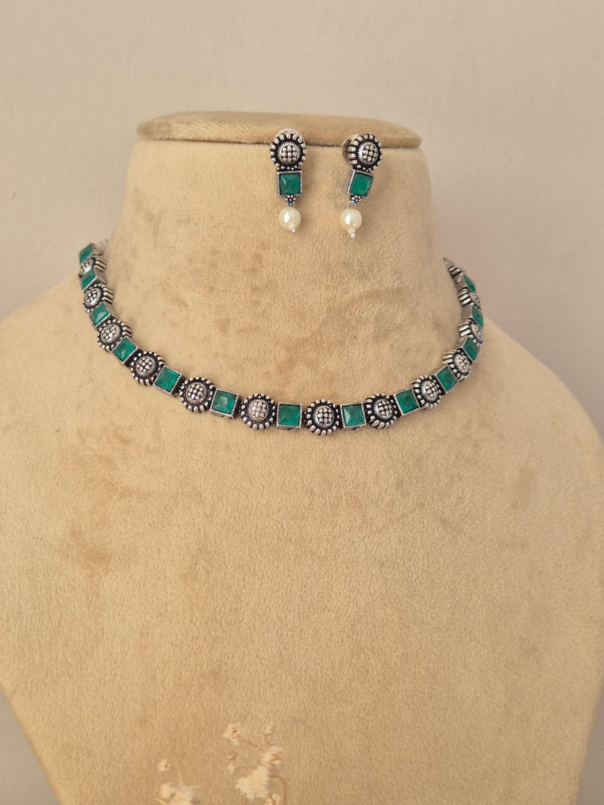 Oxidized silver choker necklace set featuring green stones and dangling mini pearls by Naitri.in