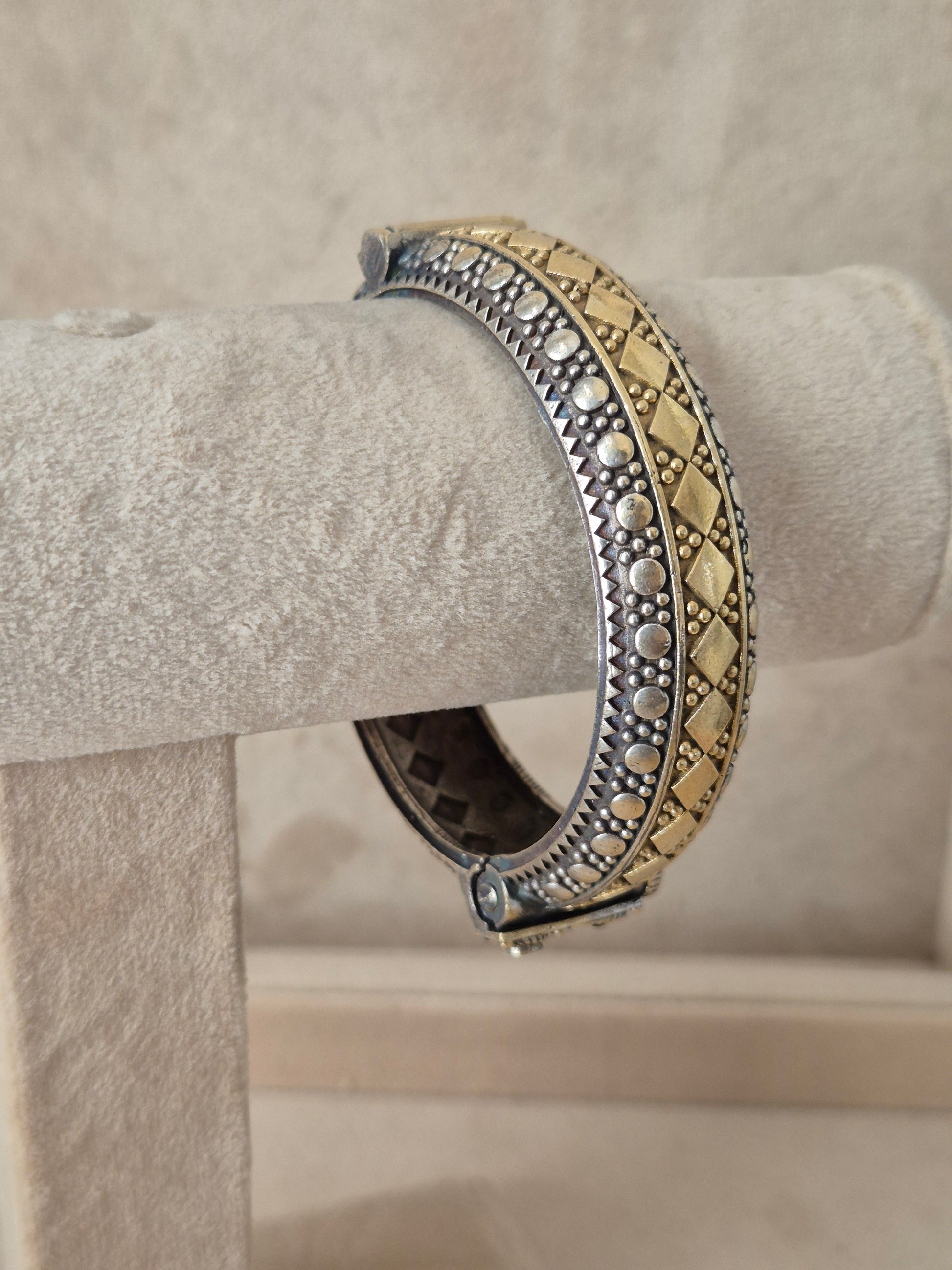 Close-up of Naitri Hina premium oxidized silver and gold dual-tone bangle bracelet with traditional Indian metalwork engraving. by naitri.in