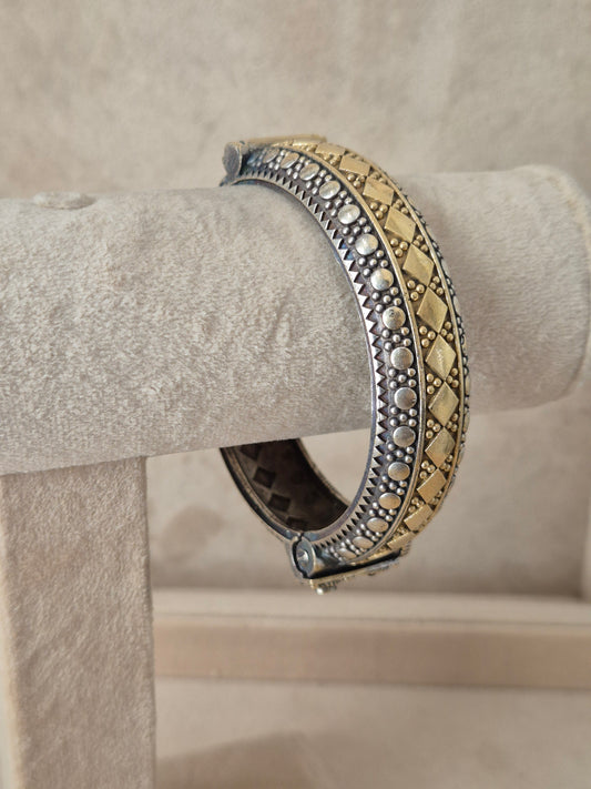 Close-up of Naitri Hina premium oxidized silver and gold dual-tone bangle bracelet with traditional Indian metalwork engraving. by naitri.in