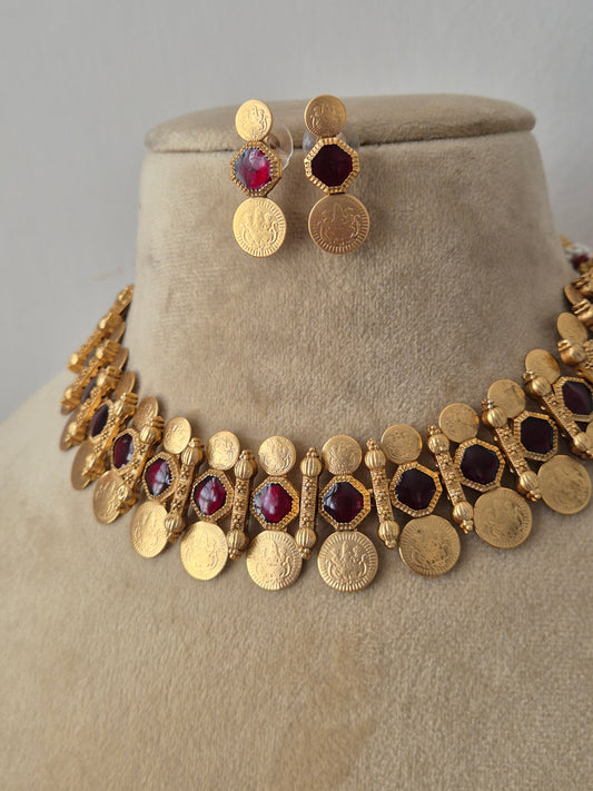 Traditional Indian gold coin choker necklace paired with matching textured round earrings, showcasing an antique finish from the Naitri Golden Ethnic Jewellery collection by naitri.in