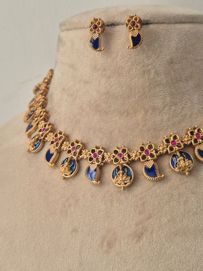 Gold-plated jewelry set featuring a necklace and matching earrings with blue enamel inlays, pink stone accents, and deity motifs, by naitri.in