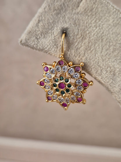 Pair of brass alloy stud earrings featuring a central cluster of vibrant red, green, and white stones arranged in a floral motif by naitri.in