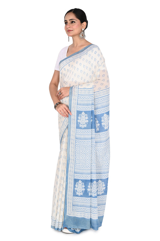 Hand block printed white cotton saree featuring intricate blue geometric and floral motifs from Bagh, Madhya Pradesh by naitri.in