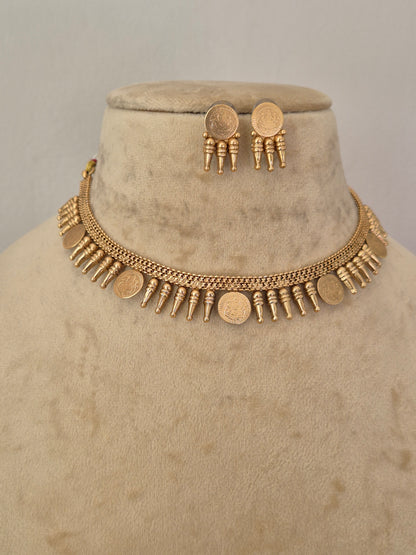 A gold-toned necklace and matching earrings Traditional gold-toned choker necklace with hanging coin elements and matching textured round earrings, by naitri.in