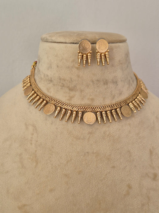 A gold-toned necklace and matching earrings Traditional gold-toned choker necklace with hanging coin elements and matching textured round earrings, by naitri.in