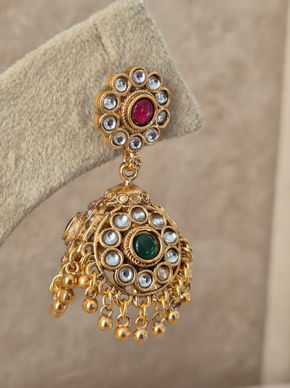 traditional gold-plated ethnic jhumka earrings featuring a circular floral stud studded with ruby-red and emerald-green stones, with tiny pearl drops by naitri.in