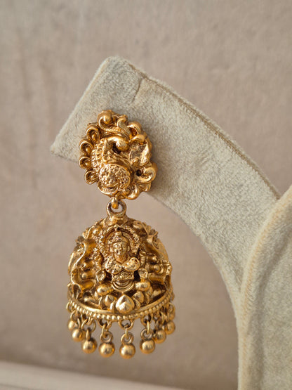 Close-up of Naitri Ishita premium gold ethnic earrings showcasing traditional Indian craftsmanship with intricate pearl work and a sophisticated polished golden finish by naitri.in