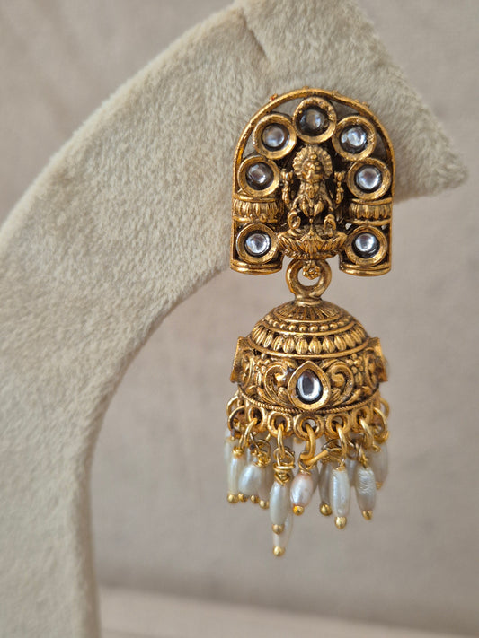 Close-up of Naitri Jaimini premium gold ethnic earrings showcasing traditional Indian temple jewelry craftsmanship with delicate pearl accents by naitri.in