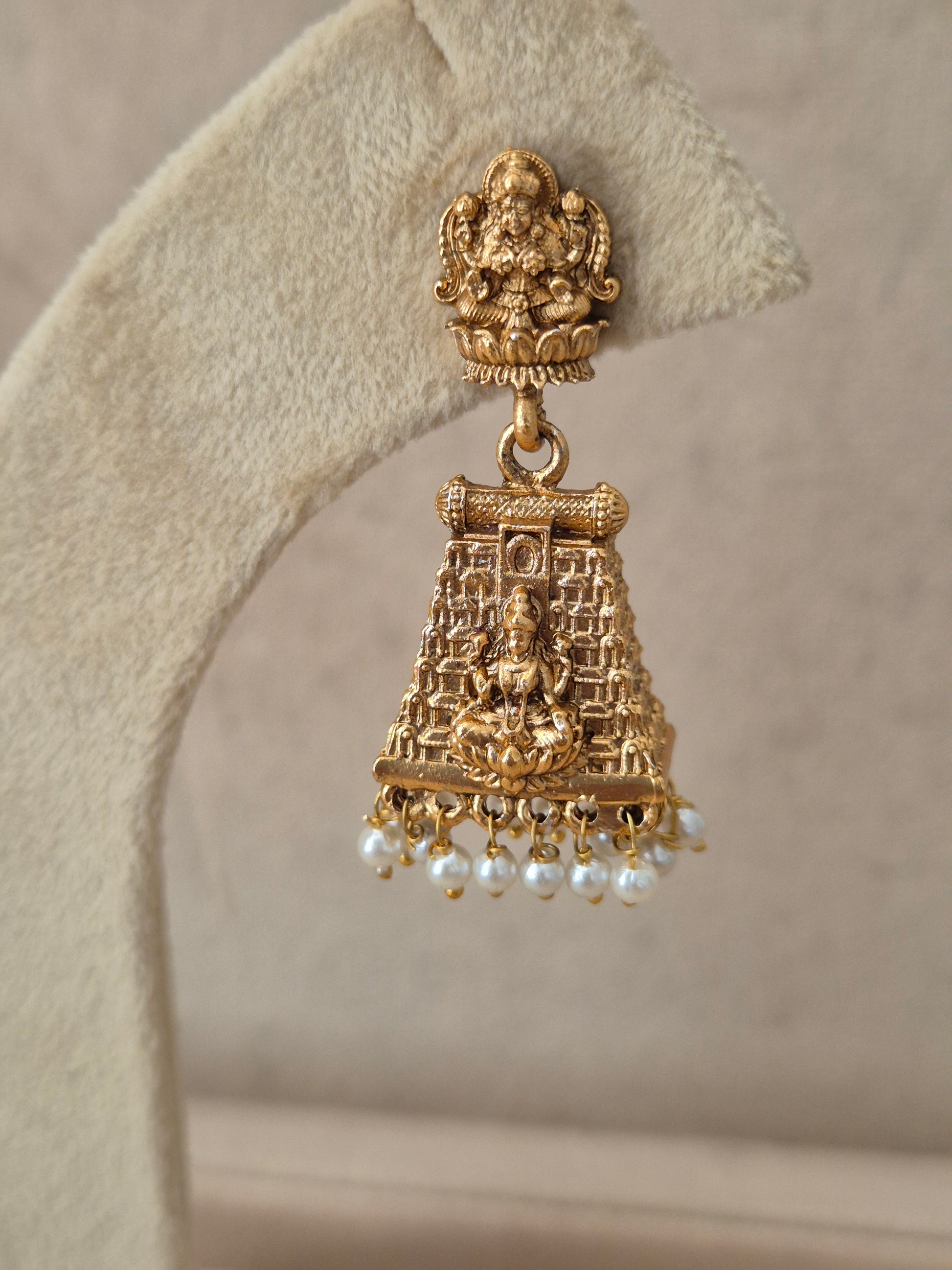 Close-up of Naitri Jayashree premium gold ethnic dangle earrings with traditional Indian craftsmanship, antique finish, and delicate pearl accent by naitri.in