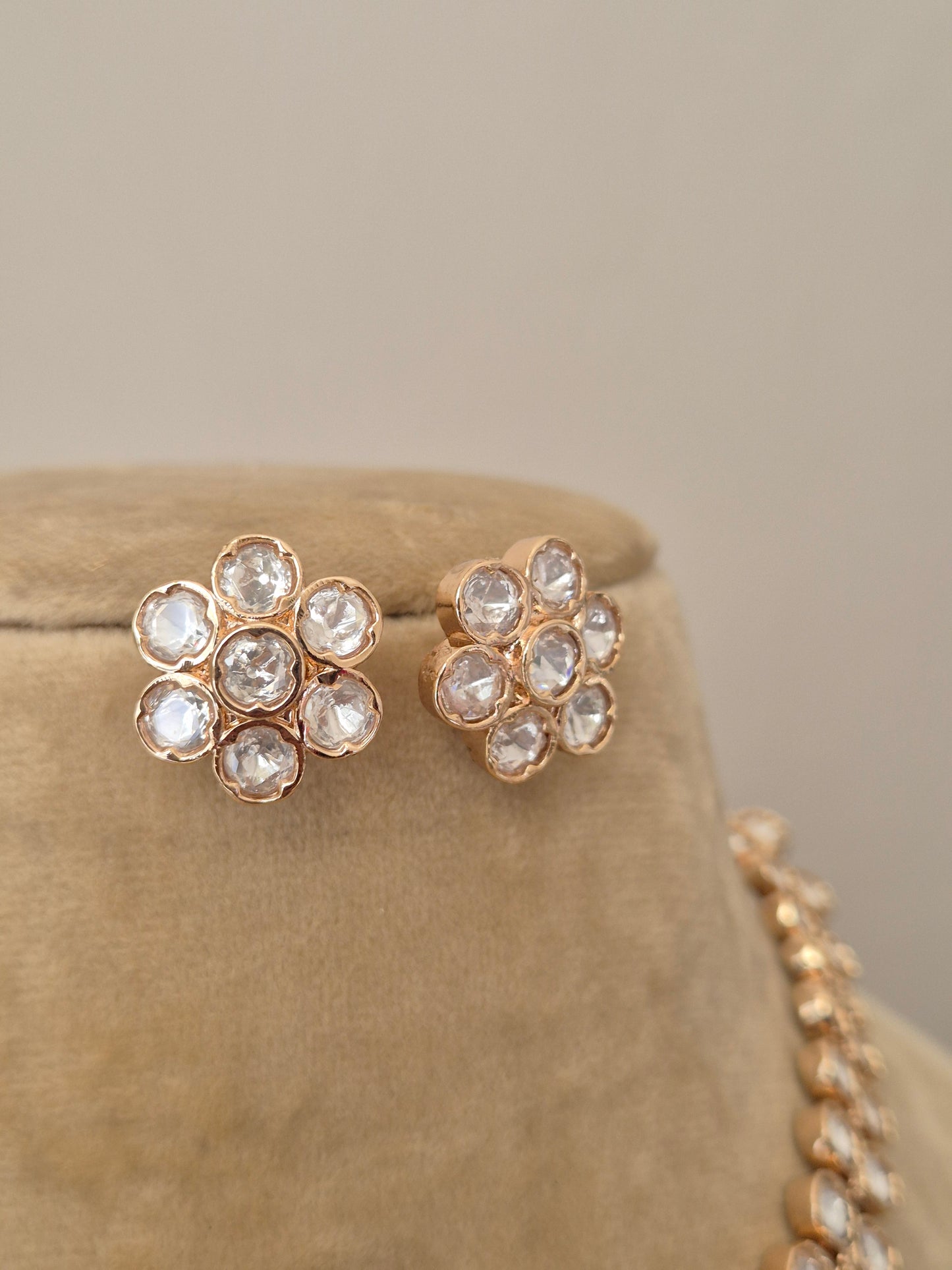 Close-up of the Jenna earrings set featuring intricate American diamond work and a polished rose gold alloy base by naitri.in 