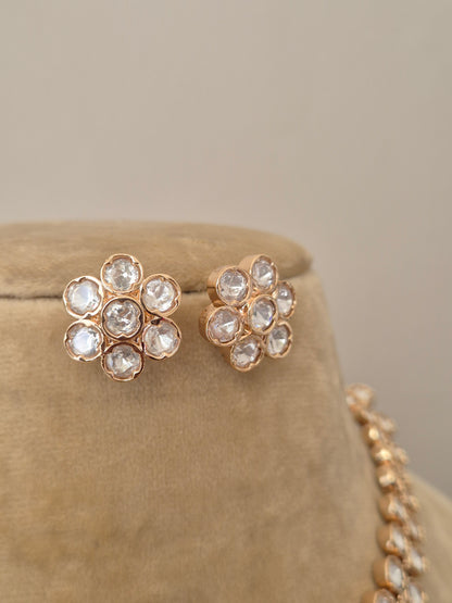 Close-up of the Jenna earrings set featuring intricate American diamond work and a polished rose gold alloy base by naitri.in 
