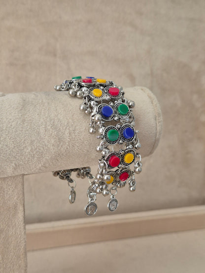 Close-up of Naitri Jharna premium oxidized silver ethnic bracelet showcasing traditional Indian multi-color enamel work with vintage dangling metallic bell charms by naitri.in