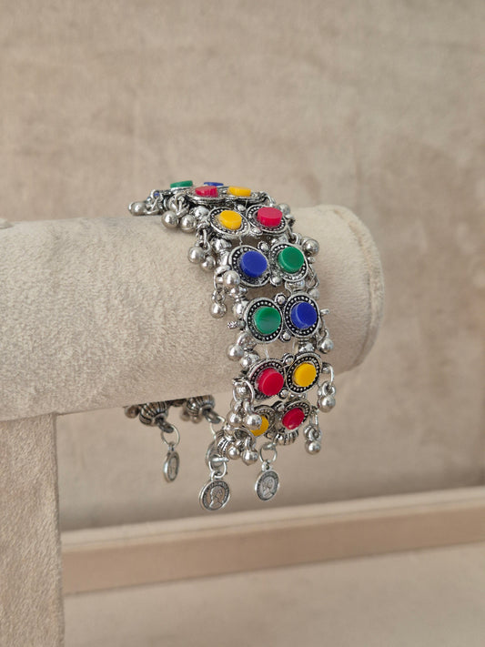 Close-up of Naitri Jharna premium oxidized silver ethnic bracelet showcasing traditional Indian multi-color enamel work with vintage dangling metallic bell charms by naitri.in