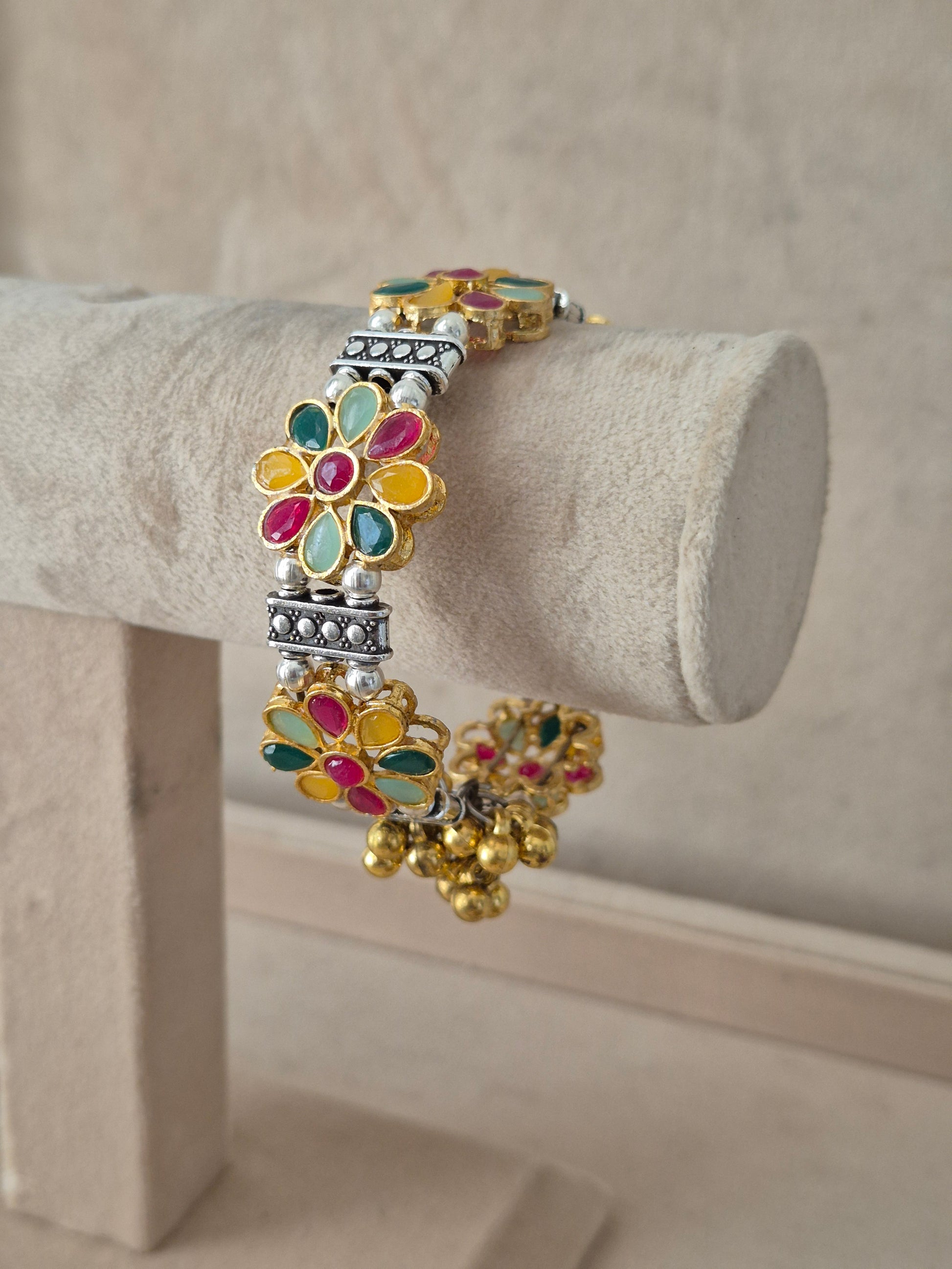Close-up of Naitri Jigesha premium mixed-metal ethnic bracelet showcasing traditional Indian multi-color enamel craftsmanship with dangling metallic bell charms by naitri.in