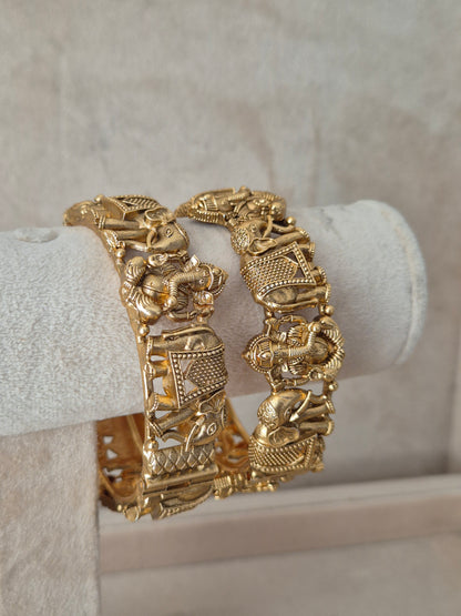 Close-up of Naitri Kavita premium gold openable bangle set with traditional Indian elephant-patterned festive metalwork by naitri.in