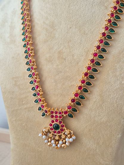 Modern Indian ethnic imitation jewelry set including a textured golden chain necklace embedded with ruby red and emerald green stones, by naitri.in