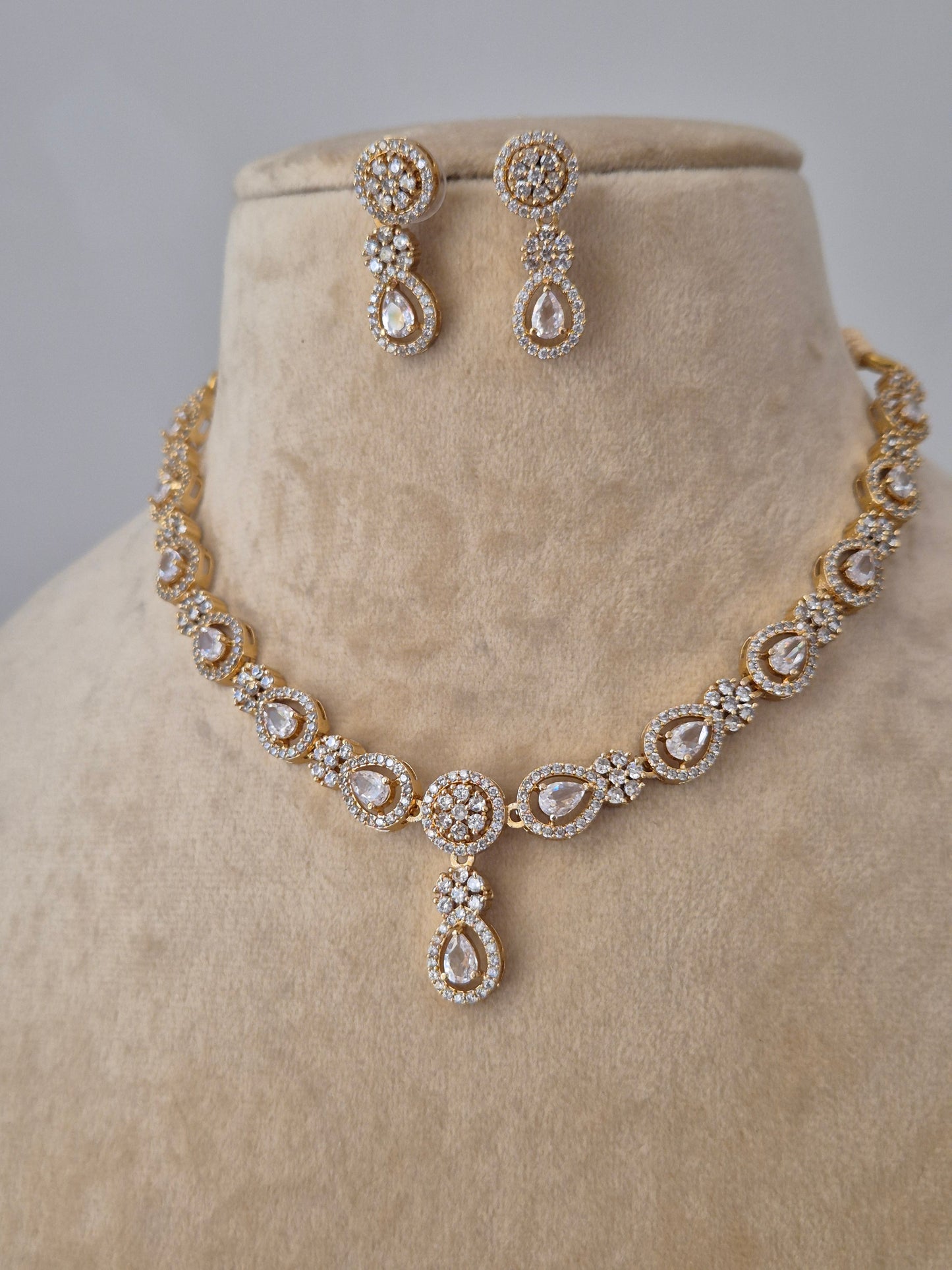 Close-up of the Lisha Necklace Set from Naitri, featuring a delicate floral stone-studded design in brass alloy by naitri.in