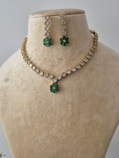 Modern Indian aesthetic Liza Necklace Set with a dainty stone-studded chain and floral emerald-green highlights, perfect for elegant ethnic wear by naitri.in