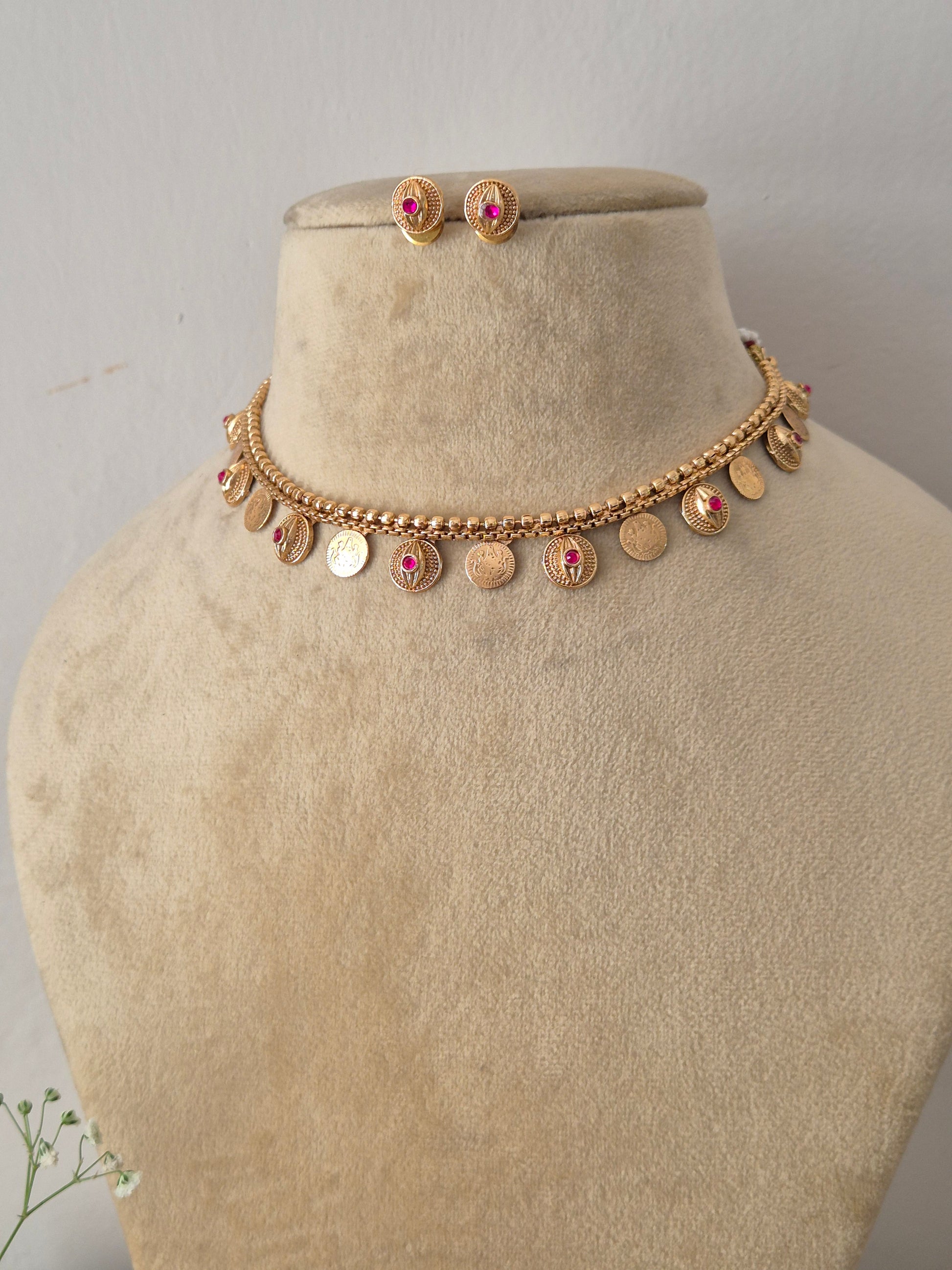 Antique gold-plated ethnic choker set featuring delicate dangling circular medallions with ruby-pink stone accents, by naitri.in