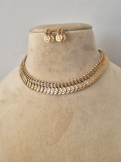 Gold-plated Indian ethnic choker set featuring multiple layered rows of textured circular coin medallions, by naitri.in