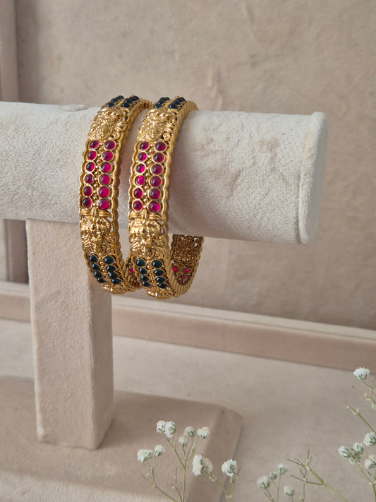 Mitanshi Bangles set of 2, traditional Indian gold-plated bangles with red and green stones, ethnic festive and wedding jewelry collection by Naitri.in