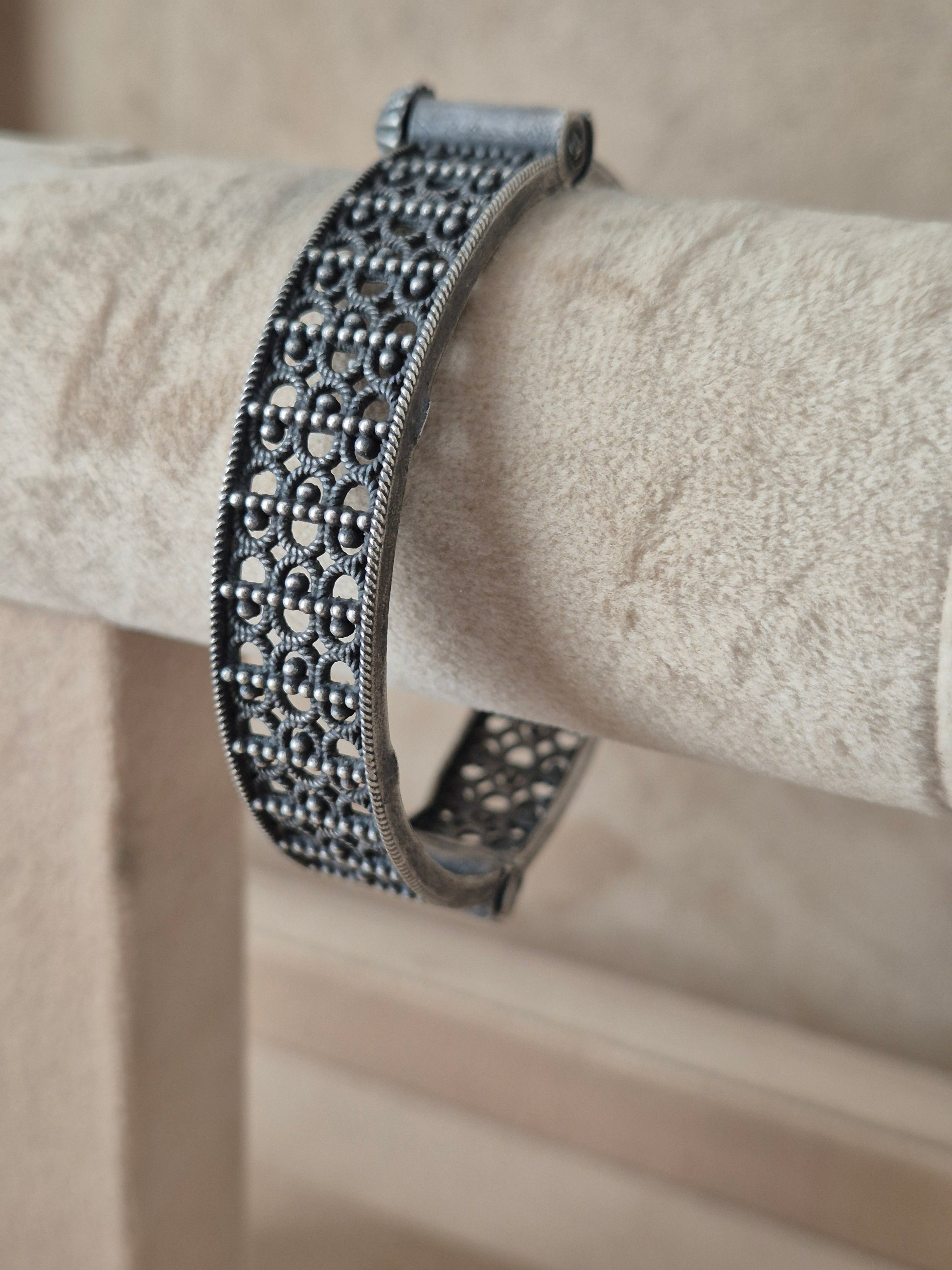lose-up of Naitri Moana premium silver oxidized bangle bracelet with traditional Indian style textured leaf and flower metalwork by naitri.in
