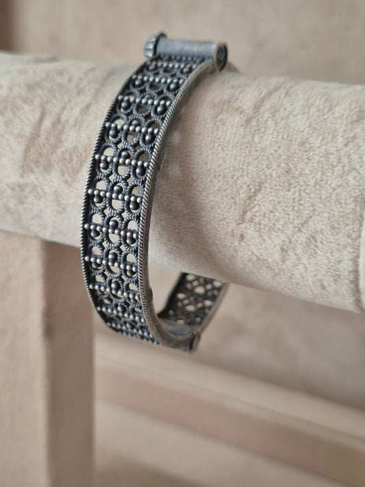 lose-up of Naitri Moana premium silver oxidized bangle bracelet with traditional Indian style textured leaf and flower metalwork by naitri.in