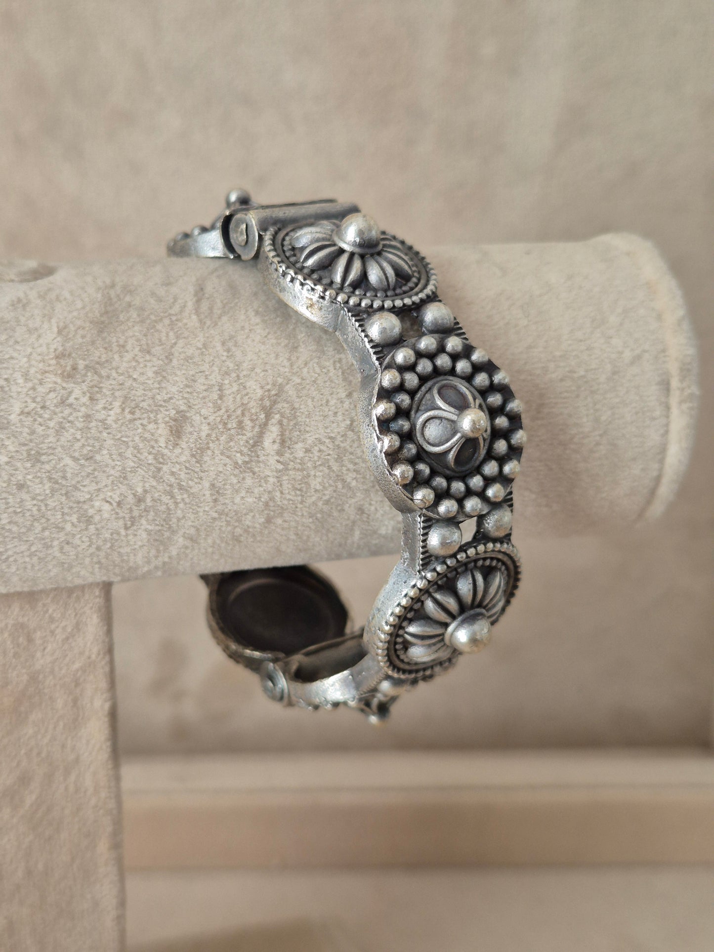 Close-up of Naitri Nafisa premium silver oxidized bangle bracelet with traditional Indian style textured leaf and flower metalwork.