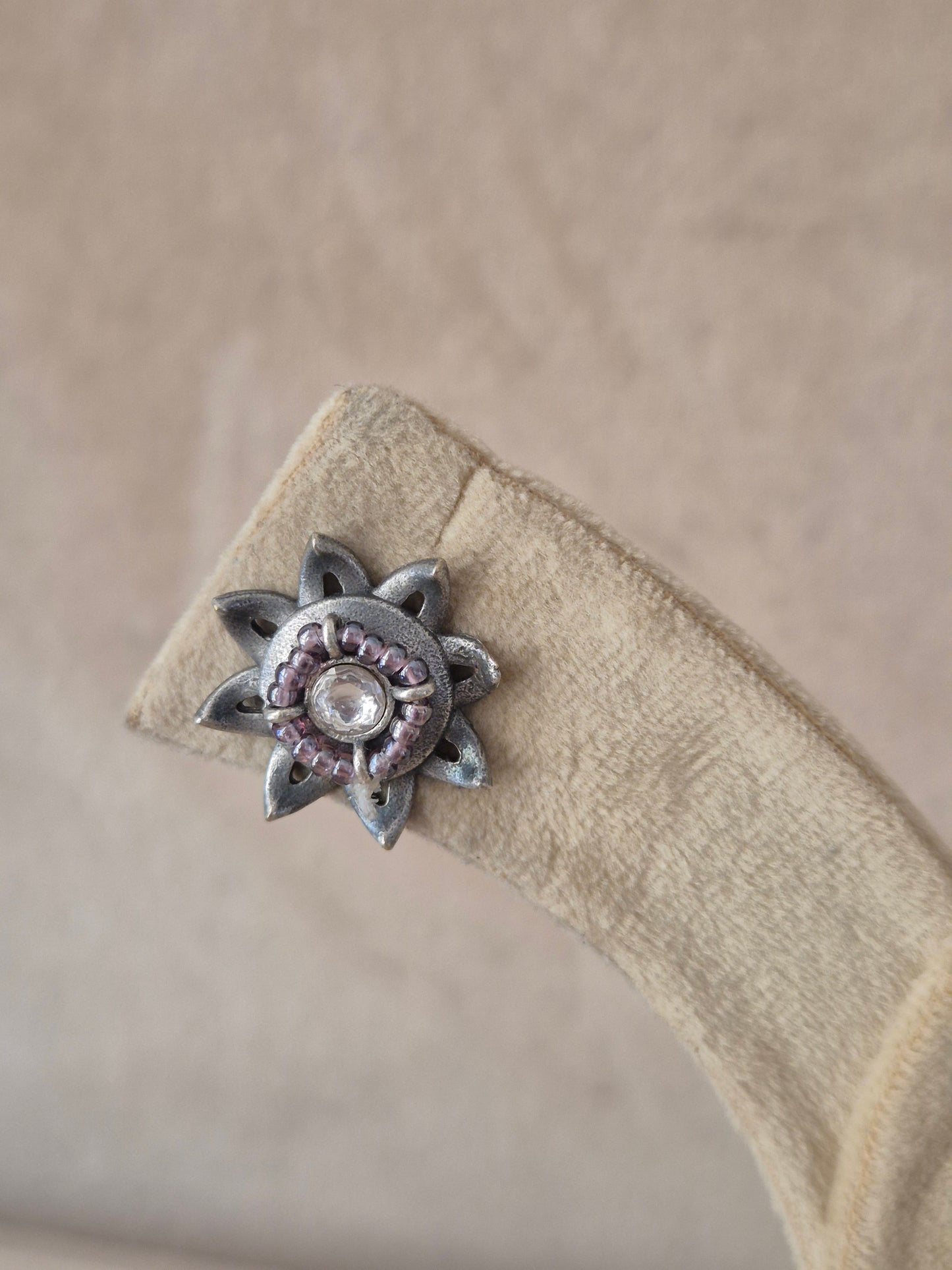 Modern Indian aesthetic silver alloy floral studs with detailed engraving and textured metallic accents by naitri.in