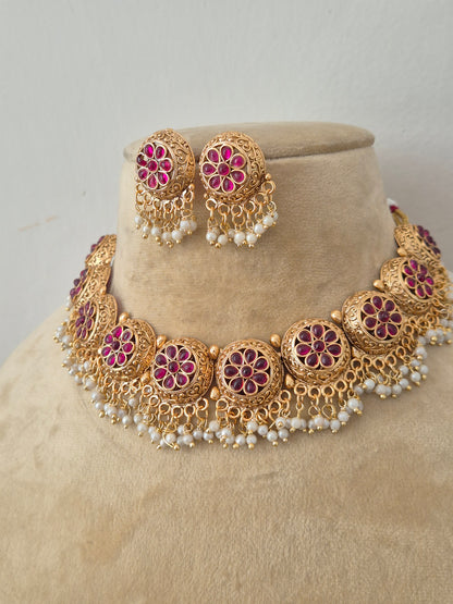 Traditional matte gold necklace set with embossed floral clusters and hanging gold bead drops, featuring intricate leaf engravings by naitri.in