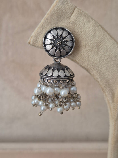 Modern Indian aesthetic silver-plated statement earrings featuring intricate mandala studs and classic jhumka styling by naitri.in