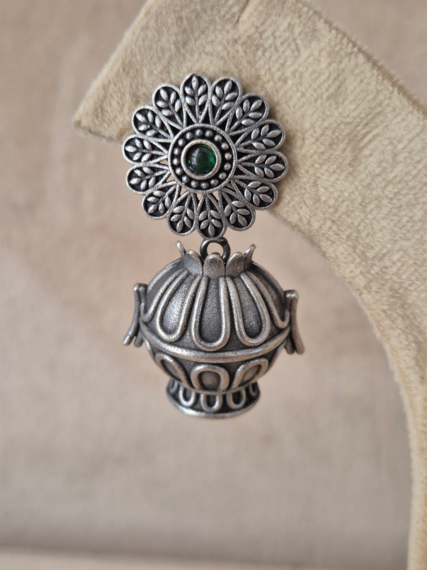 Modern Indian aesthetic silver-plated statement earrings featuring circular floral studs and classic jhumka drops by naitri.in