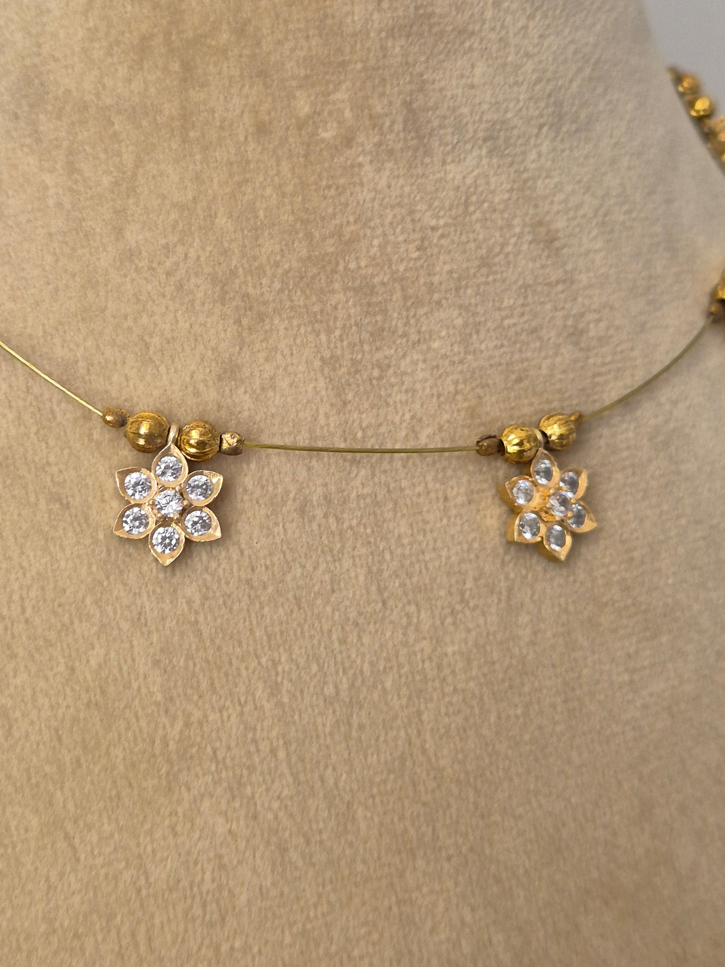 Minimalist gold-toned fine chain necklace adorned with evenly spaced hanging square pendants set with clear crystals or gemstones,  by naitri.in