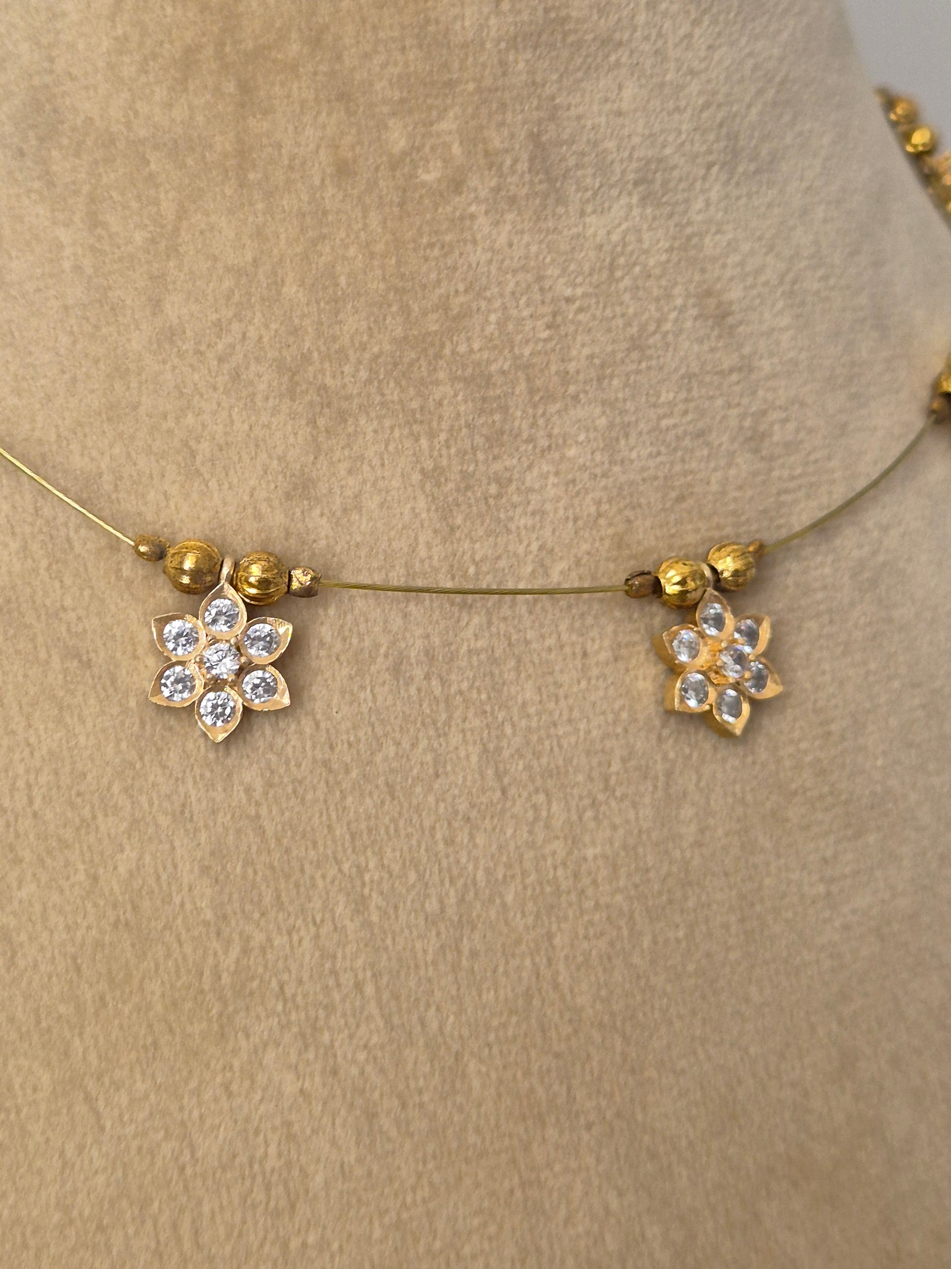 Minimalist gold-toned fine chain necklace adorned with evenly spaced hanging square pendants set with clear crystals or gemstones,  by naitri.in
