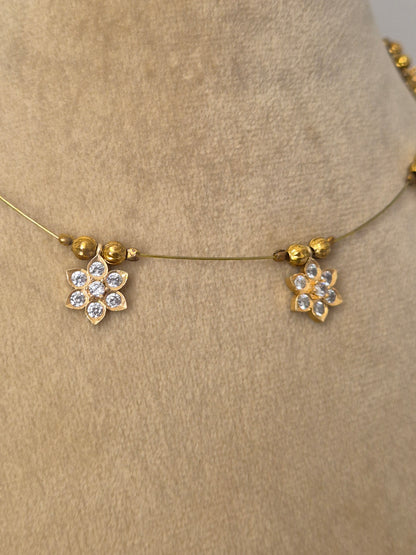Minimalist gold-toned fine chain necklace adorned with evenly spaced hanging square pendants set with clear crystals or gemstones,  by naitri.in