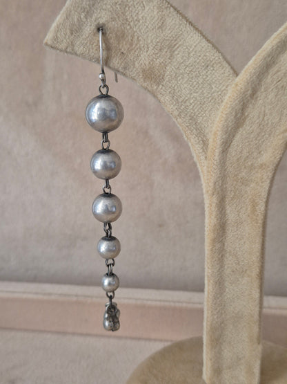 Elegant minimalist silver drop earrings featuring multiple graduated metallic beads on delicate wire hooks by naitri.in