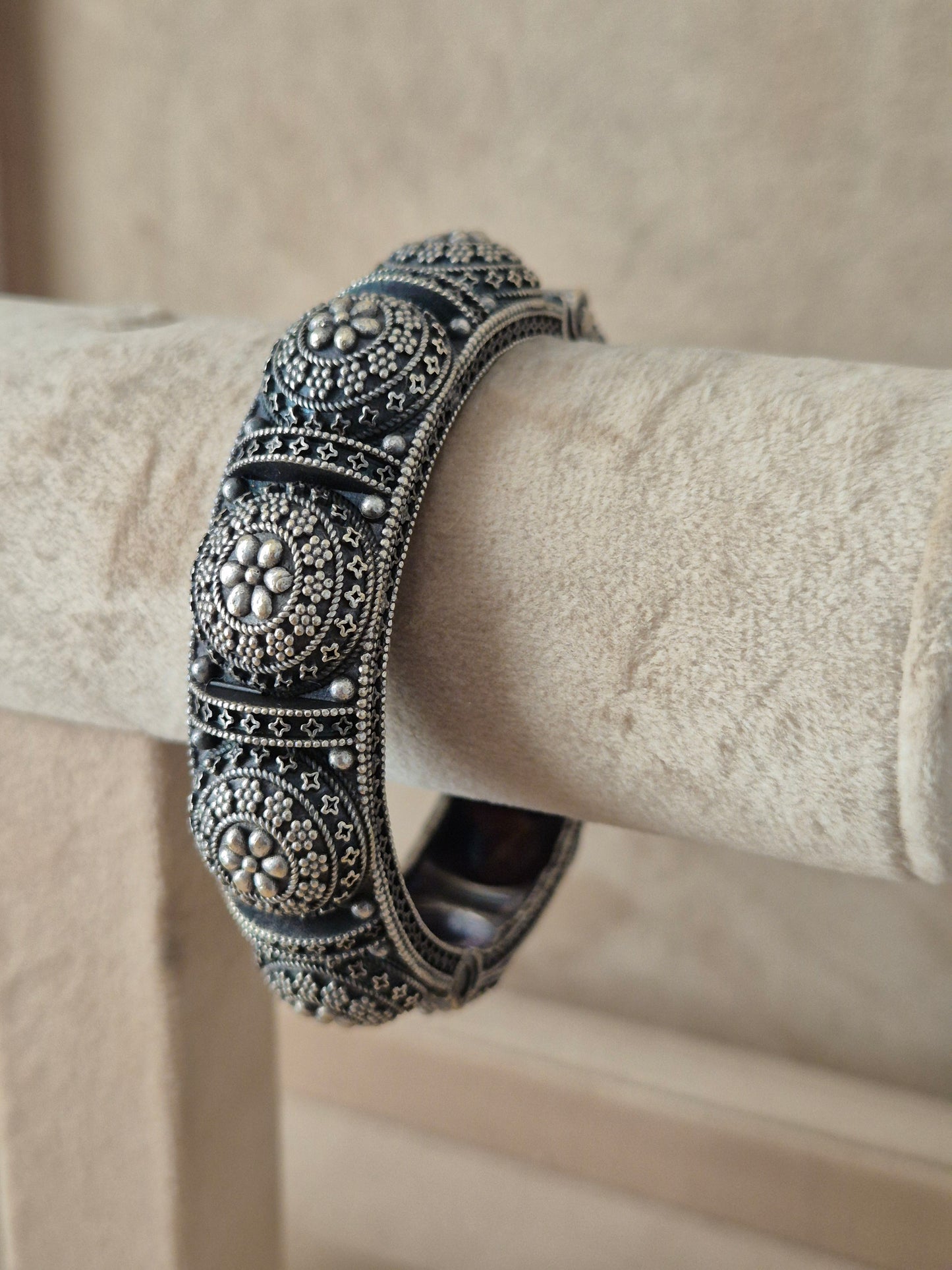 Close-up of Naitri Shilpa premium silver oxidized bangle bracelet featuring a central flower motif and detailed traditional metalwork by naitri.in