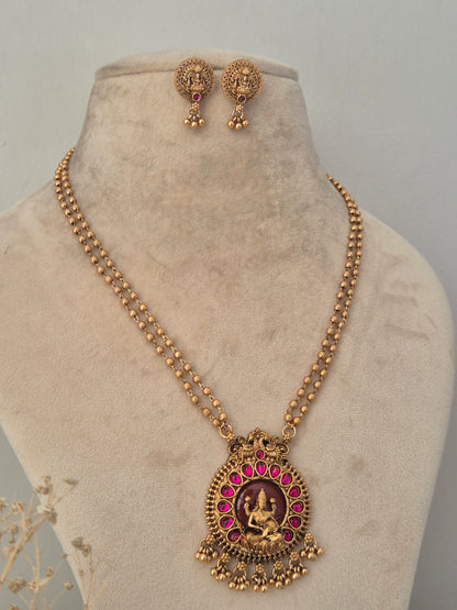 Antique gold temple chain necklace with a pink stone goddess pendant and matching dangle earrings by naitri.in