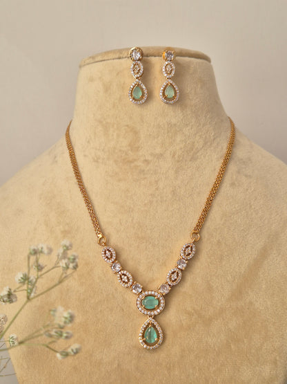 Delicate gold-plated jewelry set with pale green accents, ideal for modern ethnic styling and festive occasions by naitri.in